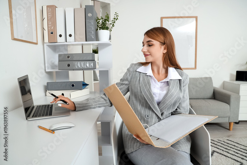 Young businesswoman working...