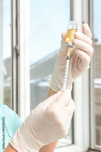 Female doctor with syringe ...
