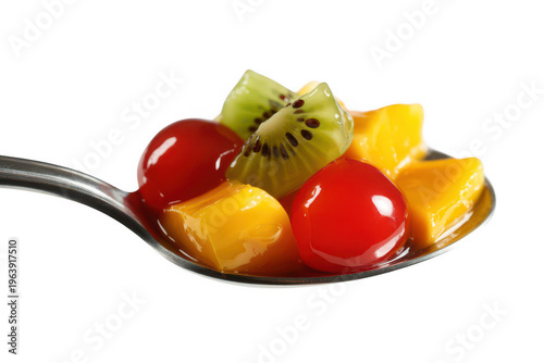 Spoon with fruit salad of kiwi, mango, and cherries isolated on a transparent background