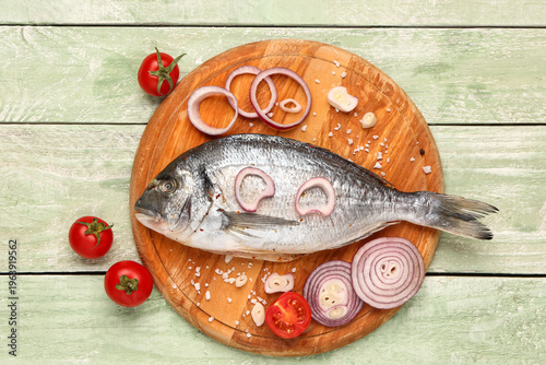 Board of raw dorado fish wi...