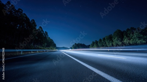 Night Highway with Light Trails Through Dark Forest: Modern Transportation and Infrastructure