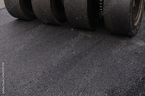 The car wheels are grinding on the asphalt road