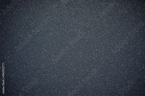 Dark gray sandpaper texture with fine gritty particles and vignette