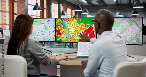 Fotografie Two GIS Analysts In Office Using Computers To Review Urban Planning Maps