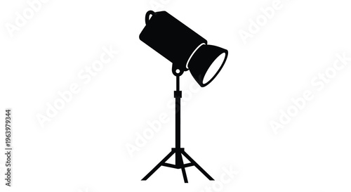 A stark black silhouette depicts a studio spotlight on a tripod suggesting illumination and photography high quality professional detailed modern elegant