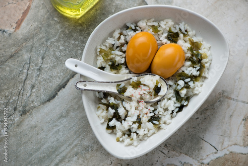 Fotografie Wakame gohan with marinated eggs on a grey granite background, horizontal shot,