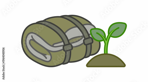 Camping sleeping bag next to a small plant growing in soil