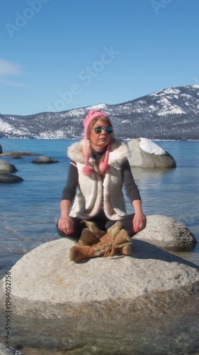 Girl sitting on a rock in Lake Tahoe. Vertical design in 9:16 ratio. Smartphone and social media 