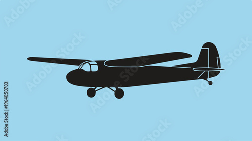 Silhouette of a glider aircraft soaring through the clear blue sky.