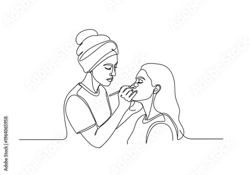 Female makeup artist applying cosmetics to client's face on minimalist background