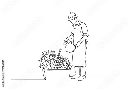 Male gardener watering plants with watering can on minimalist background