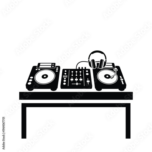 DJ setup with turntables mixer and headphones on a table.