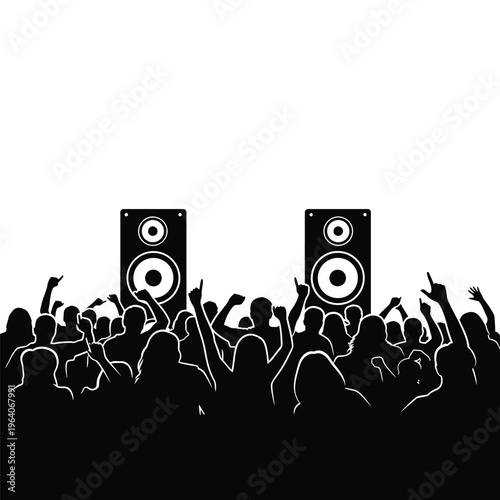 Silhouettes of a crowd dancing at a concert with large speakers.