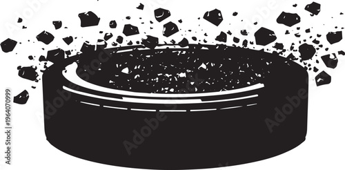 Black ice hockey puck shattering into small fragments on a white background