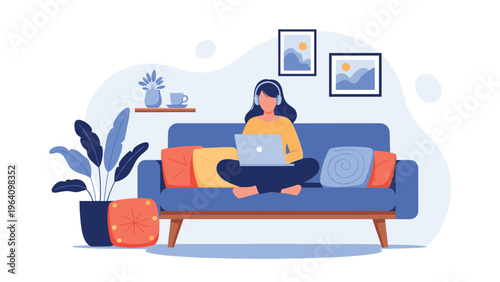 Young woman works remotely on her laptop while sitting comfortably on a blue sofa with headphones in a cozy home environment.