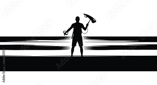 Kitesurfer stands ready on the beach a striking black silhouette