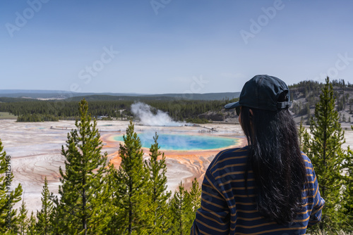Woman hiker overlooking Grand Prismatic Spring in Yellowstone