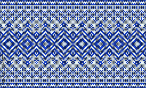 A cross-stitch pattern in blue and white tones, in an ethnic or native Indian style.