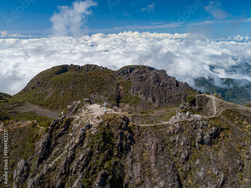 Картината върху платно Volcan Baru summit cross rising above a vast expanse of clouds, showcasing the s
