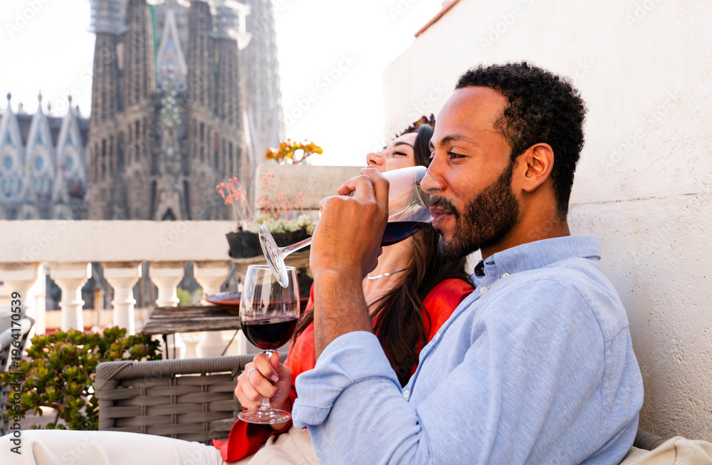 Naklejka premium Multiracial beautiful happy couple of lovers dating in Barcelona on a rooftop with amazing city view