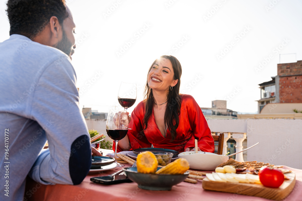 Naklejka premium Multiracial beautiful happy couple of lovers dating in Barcelona on a rooftop with amazing city view