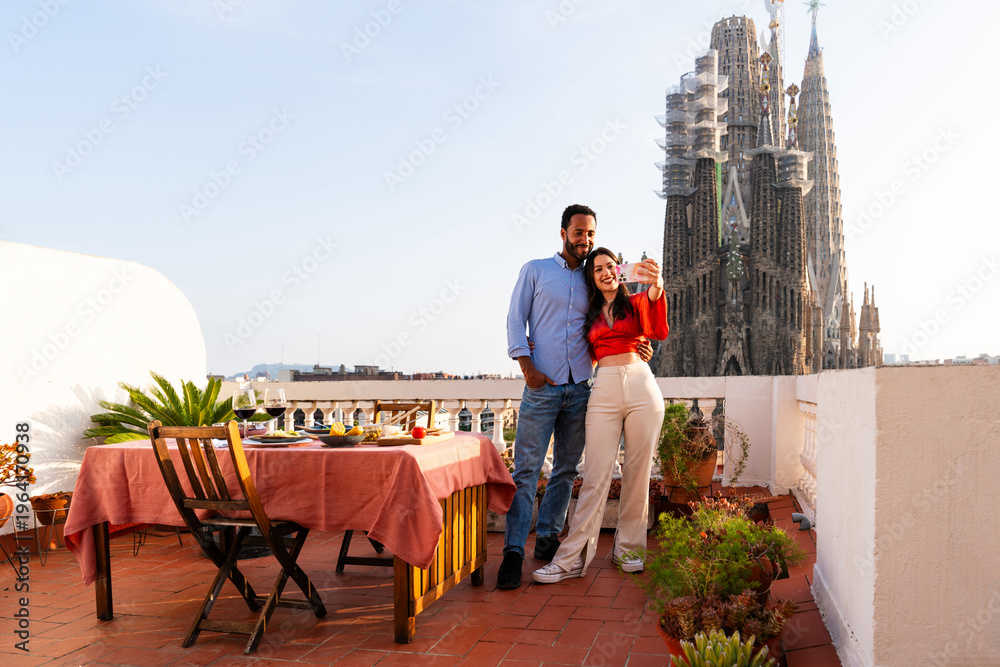 Obraz premium Multiracial beautiful happy couple of lovers dating in Barcelona on a rooftop with amazing city view