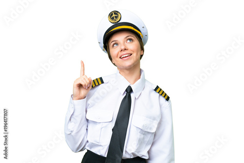Airplane pilot woman over isolated chroma key background pointing up and surprised