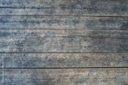 Vintage grunge wooden board background with old weathered texture. Rustic grey wood planks for commercial copy space. Antique timber surface top view.