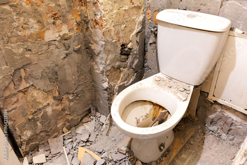 Renovation in the toilet, ceramic tiles removed from the walls and floor.
