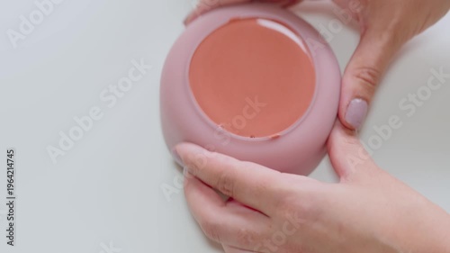 Hands Holding Pink Cream Blush Compact With Manicured Nails Beauty Makeup Product Close-Up