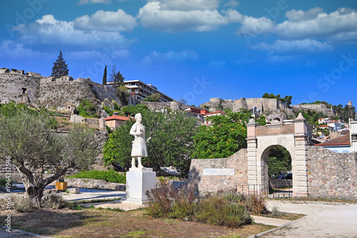 Statue of Staikos Staikopoulos, liberator of Nafplio and Lion gate in city of Nafplio, Greece