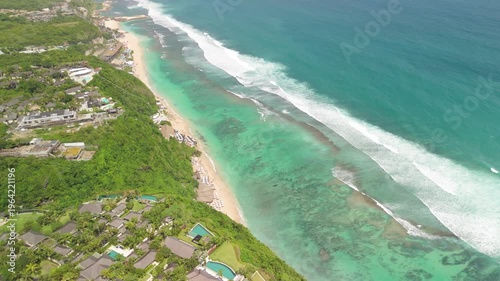 4K drone footage of Uluwatu, Bali: dramatic cliffs, crashing waves and turquoise ocean under bright daylight. Perfect for travel, nature, adventure and tropical destination projects
