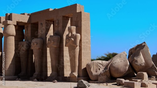 Ruins of Ramesseum mortuary temple with giant Ramesses II Osiride statues. It is located in the Theban necropolis in Upper Egypt, across the River Nile from the modern city of Luxor. Egypt.
