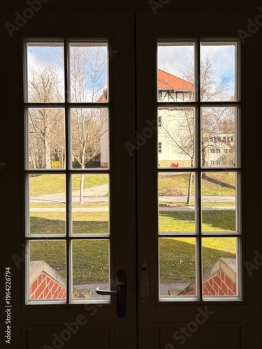 View from a window overlooking historic buildings in a city, classic architecture, old town streets, daytime urban scene