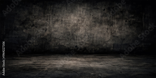 Empty dark room with a textured gray concrete wall and aged cement floor creates a vintage grunge interior backdrop for design space