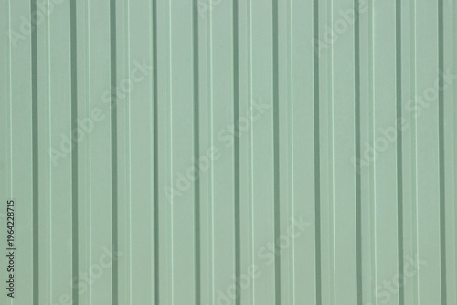 Mint green background with large raised stripes on a flat surface.