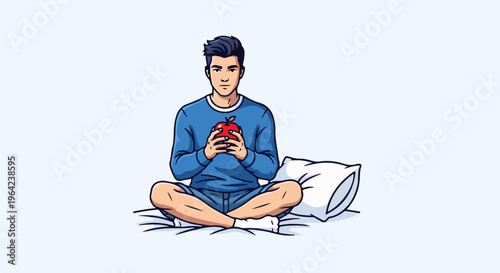 Young man sits cross-legged in bed holding a red apple