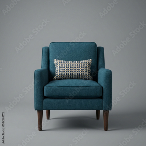 A comfortable armchair with a small pillow rests on dark wooden legs against a plain background
