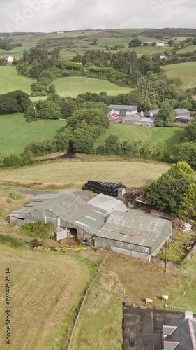 Overlooking lush green rolling hills and traditional farmhouses nestled in the European countryside.