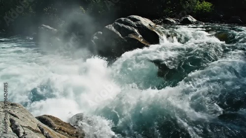Dynamic rush of crystal-clear river water cascading over rugged rocks, creating a mesmerizing display of foamy white rapids and natural power in a pristine wilderness setting