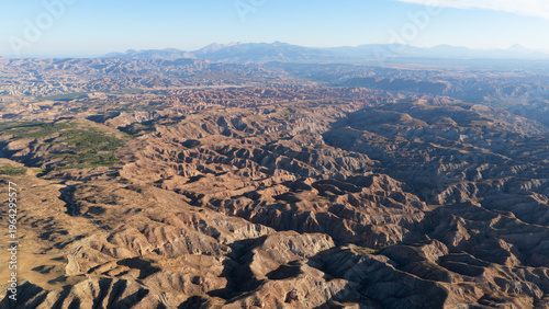 Vast abstract desert landscape with deeply eroded hills and canyons, showcasing the unique geological formations of Gorafe badlands