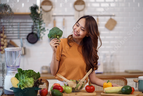 Young woman cooking fresh vegetables for a healthy lifestyle and balanced nutrition in modern kitchen.