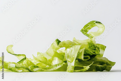 Freshly cut romaine lettuce forming an appetizing green pile on white background