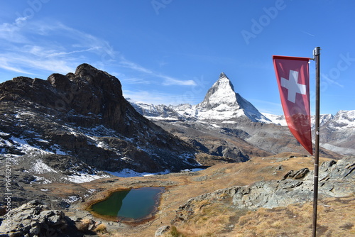 Matterhorn and Swiss flag near Zermatt in the Swiss Alps