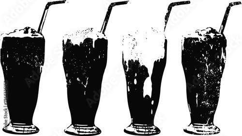 Four tall glasses of milkshakes with whipped cream and straws standing in a row