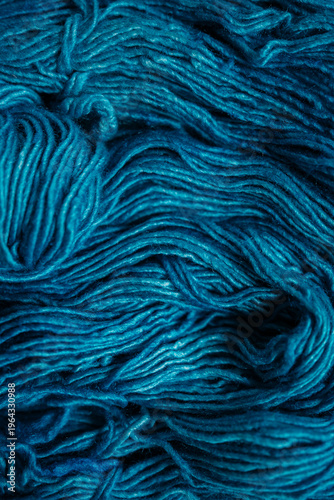Detailed close-up of dark teal wool yarn texture, messy and soft fibers, rich abstract background for handmade and cozy design concepts