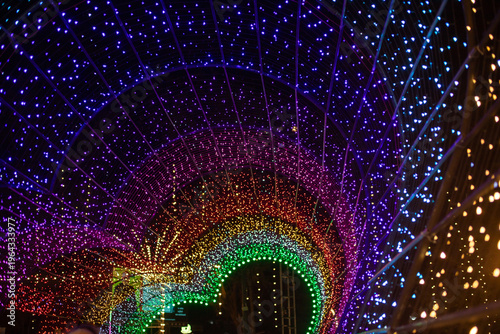 Glowing rainbow lights arranged in the shape of a heart. Decorative lighting that creates a dynamic and modern nighttime backdrop.