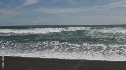 Sunny Day at South Coast Beach Indonesia with Blue Ocean Waves and Clear Sky