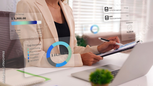 Canvas-taulu Businesswoman analyzing financial data on an augmented reality interface for bud