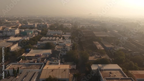 Aerial Sweep of Industrial Rooftops Featuring Corrugated Sheds and Solar Power Systems.
